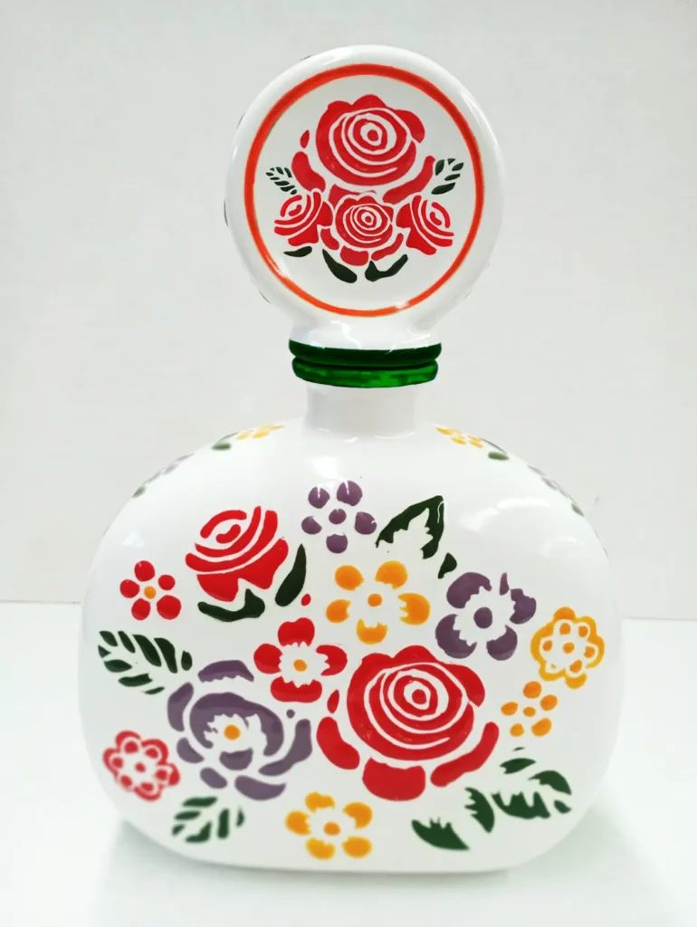 A ceramic bottle painted with flowers