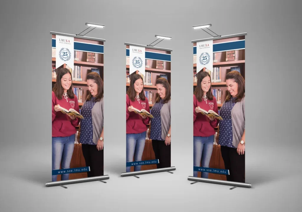 Three pull-up banners with students reading
